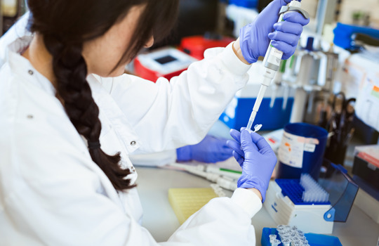 FISH laboratory scientist aliquoting a sample.