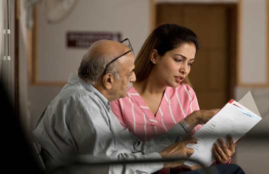Doctor showing test results to a patient.